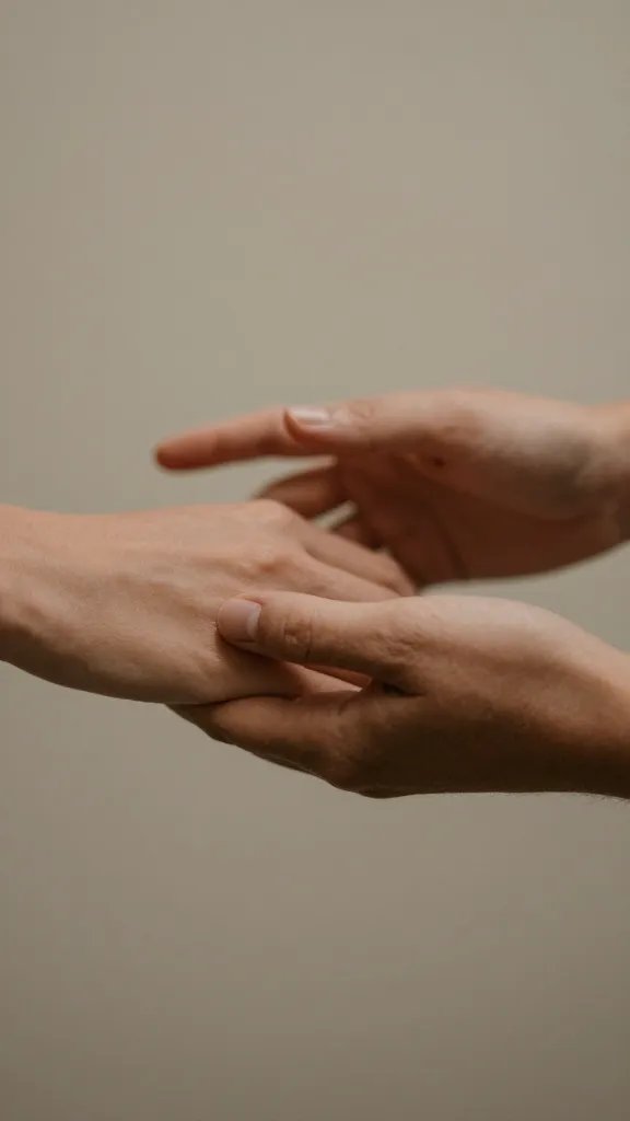 closeup of a couple’s hands reaching toward each other in a calm conversation vignette
