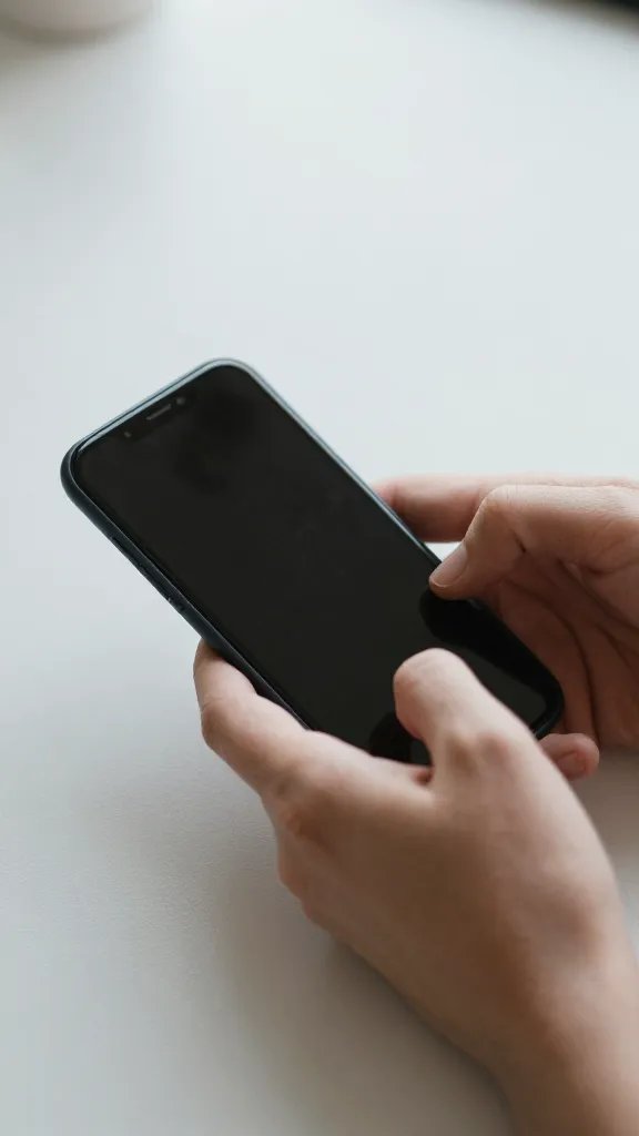 Closeup of hands setting a phone down on a calm desk