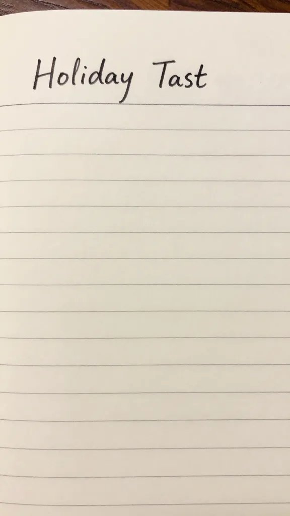 Closeup of a handwritten holiday task list on a desk