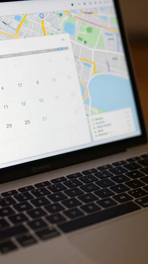 Closeup of a calendar and map view on a laptop screen, gentle desk lighting