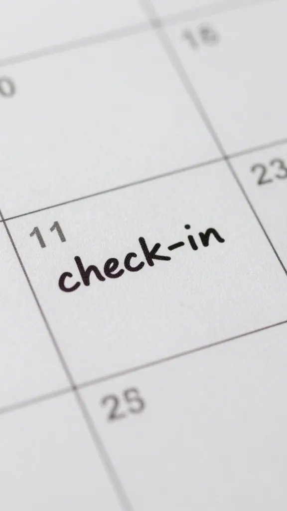 Closeup of a calendar page with a “check-in” note written, focused