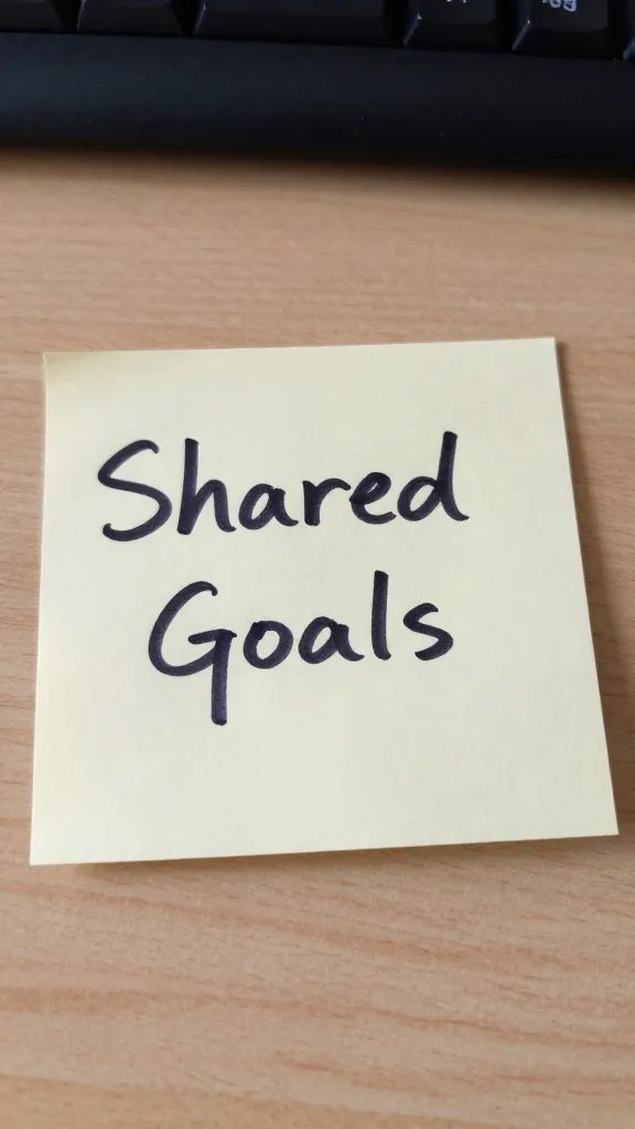 focused shot of a single handwritten note about shared goals on a desk