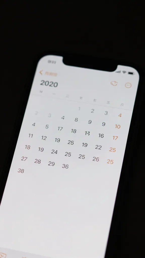 Closeup of a single smartphone screen displaying a calendar alert, dimmed lighting