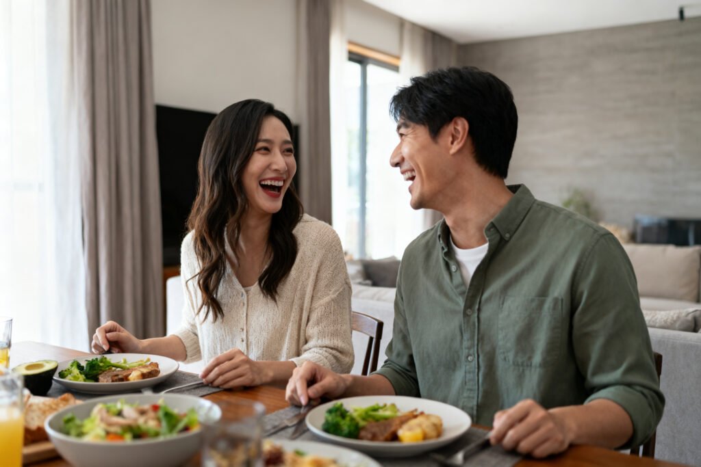 A couple laughing over dinner