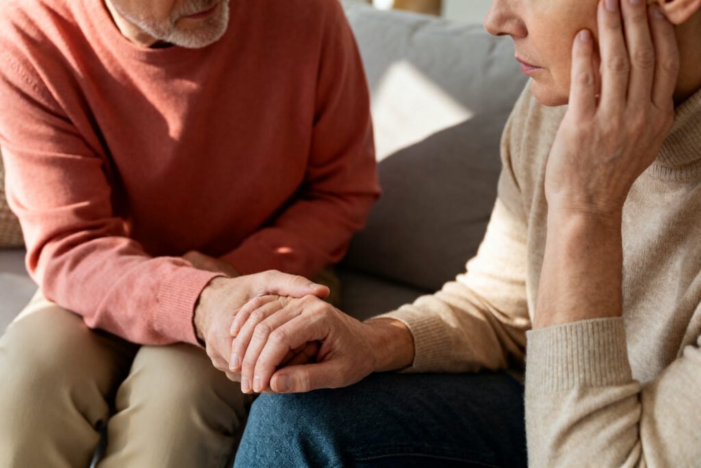 One partner listening with empathy and holding the other hand