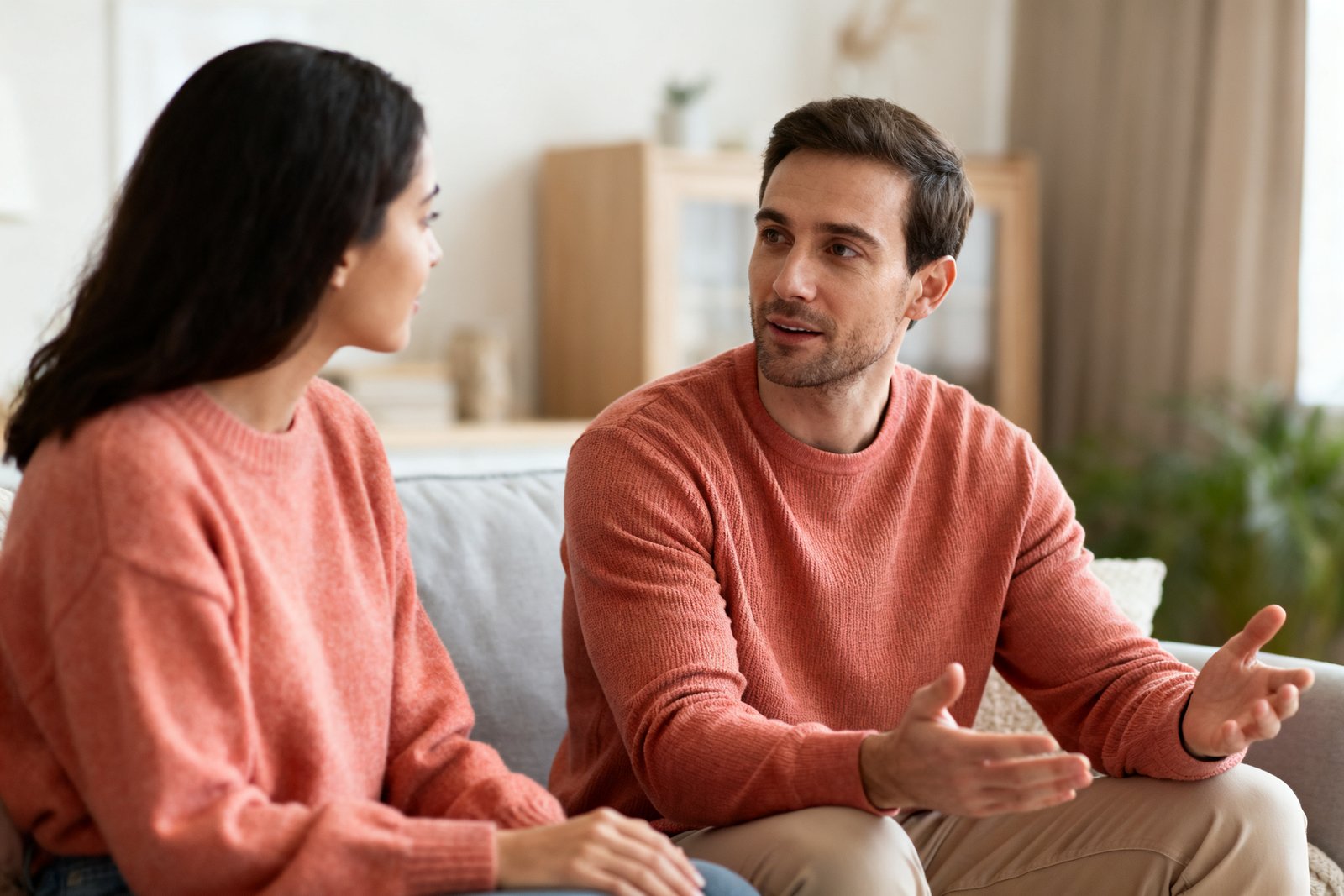 A couple having a calm conversation, one listening patiently with open posture