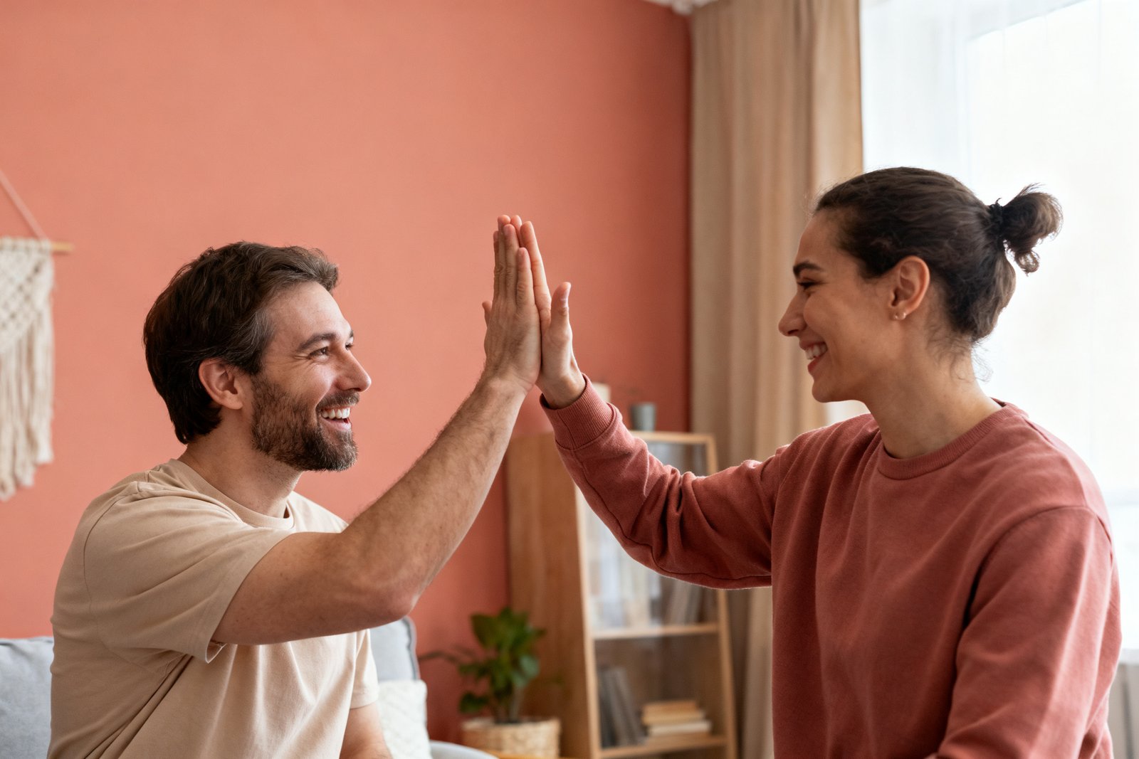 Partners celebrating a small shared win with a high five
