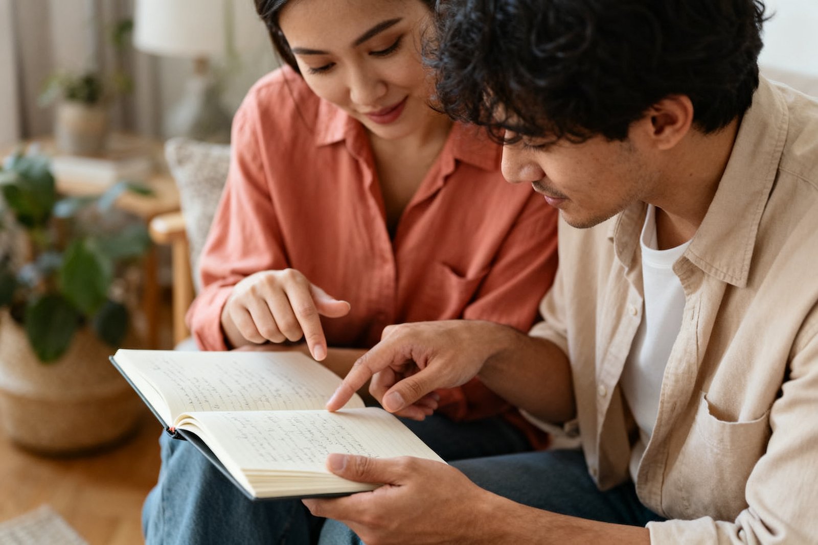 A couple planning something together over a notebook