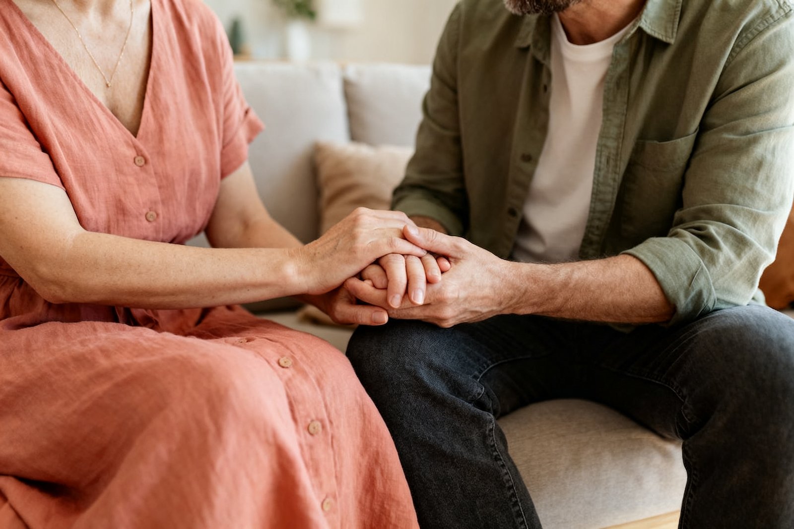 A couple holding hands during a sensitive conversation